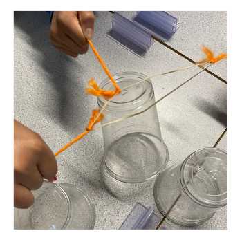 Students playing an icebreaker cup stacking game