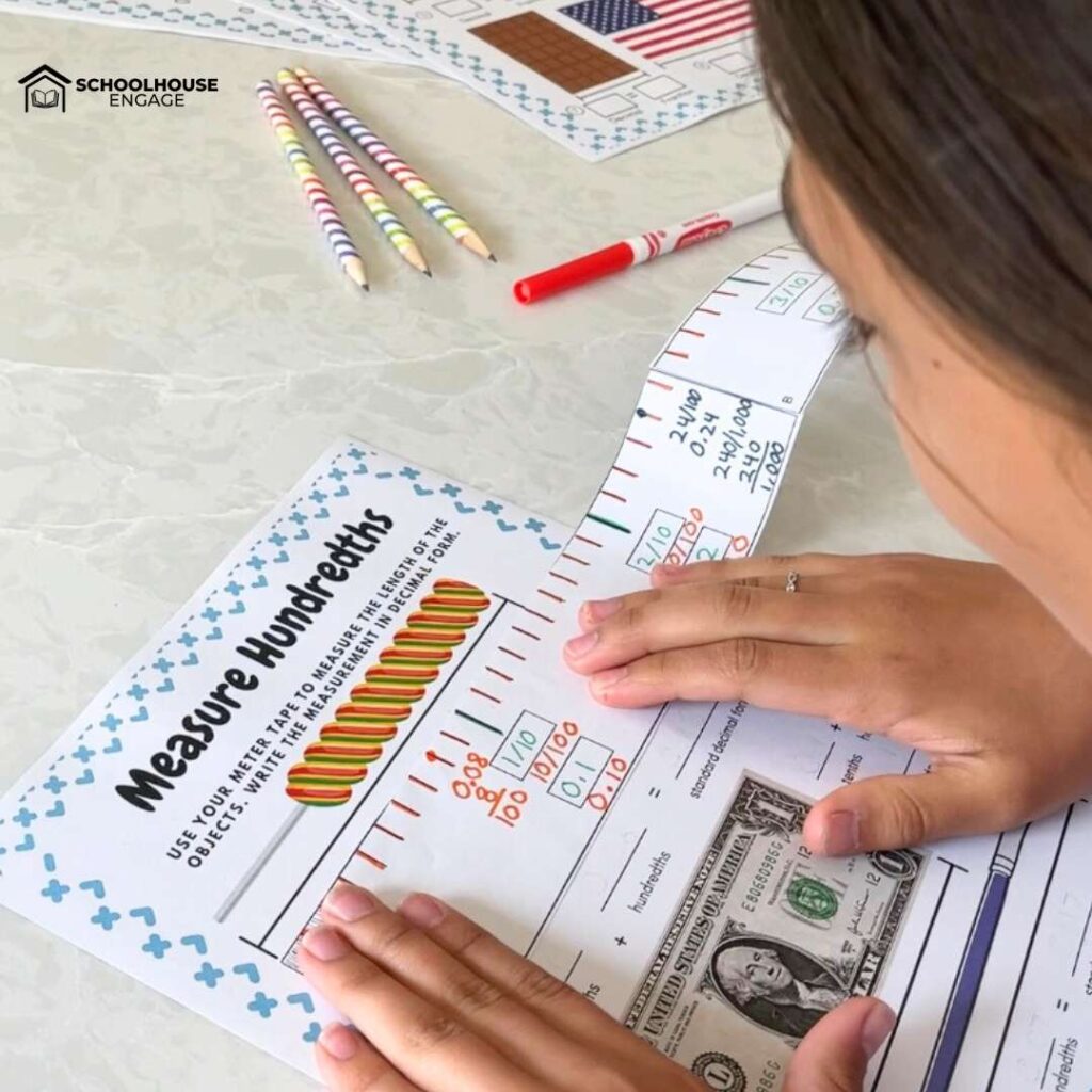 Student measuring up to hundredths decimal with a DIY meter tape