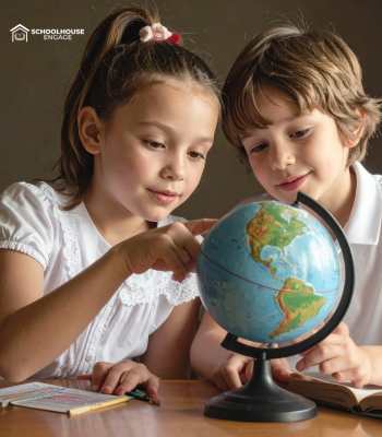 A boy and girl looking at a globe